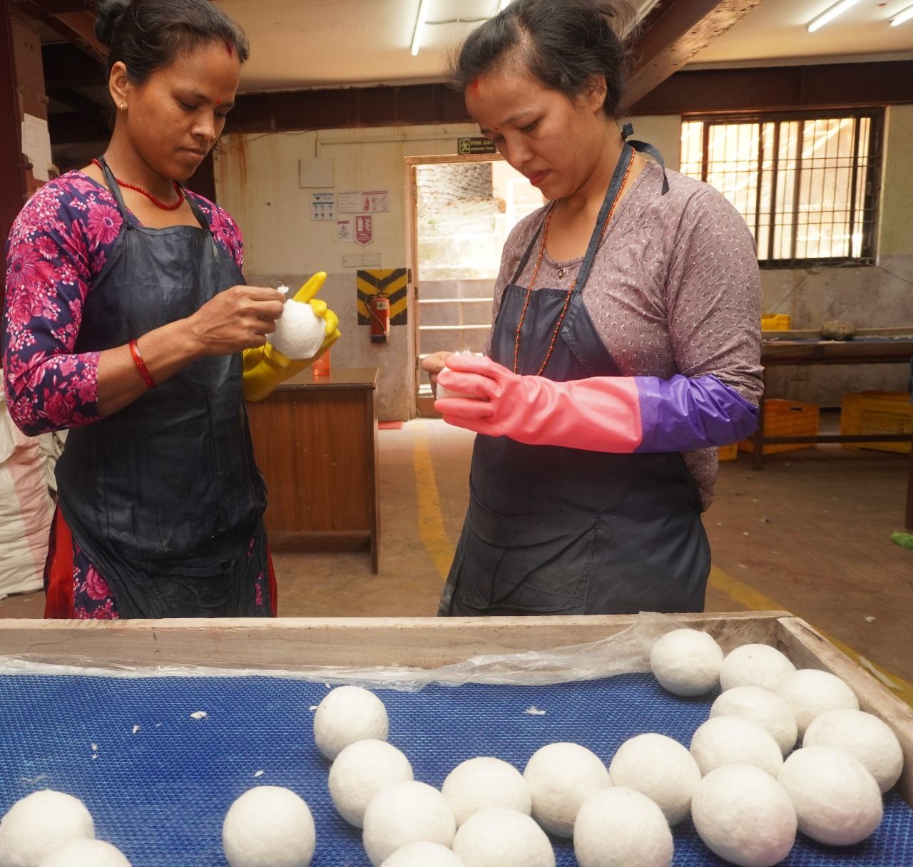 Hands shaping wet wool with soap and water